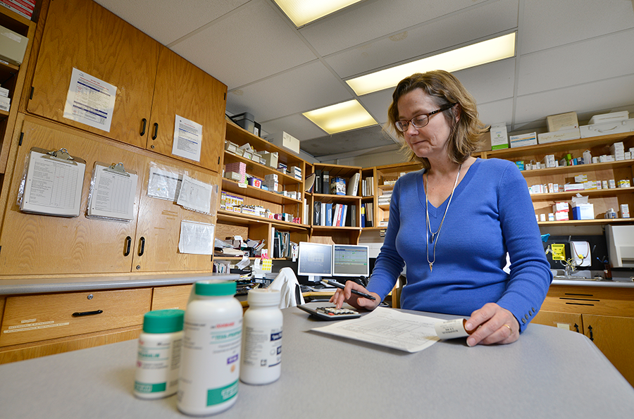 pharmacy director reviewing paperwork in pharmacy department at SMH